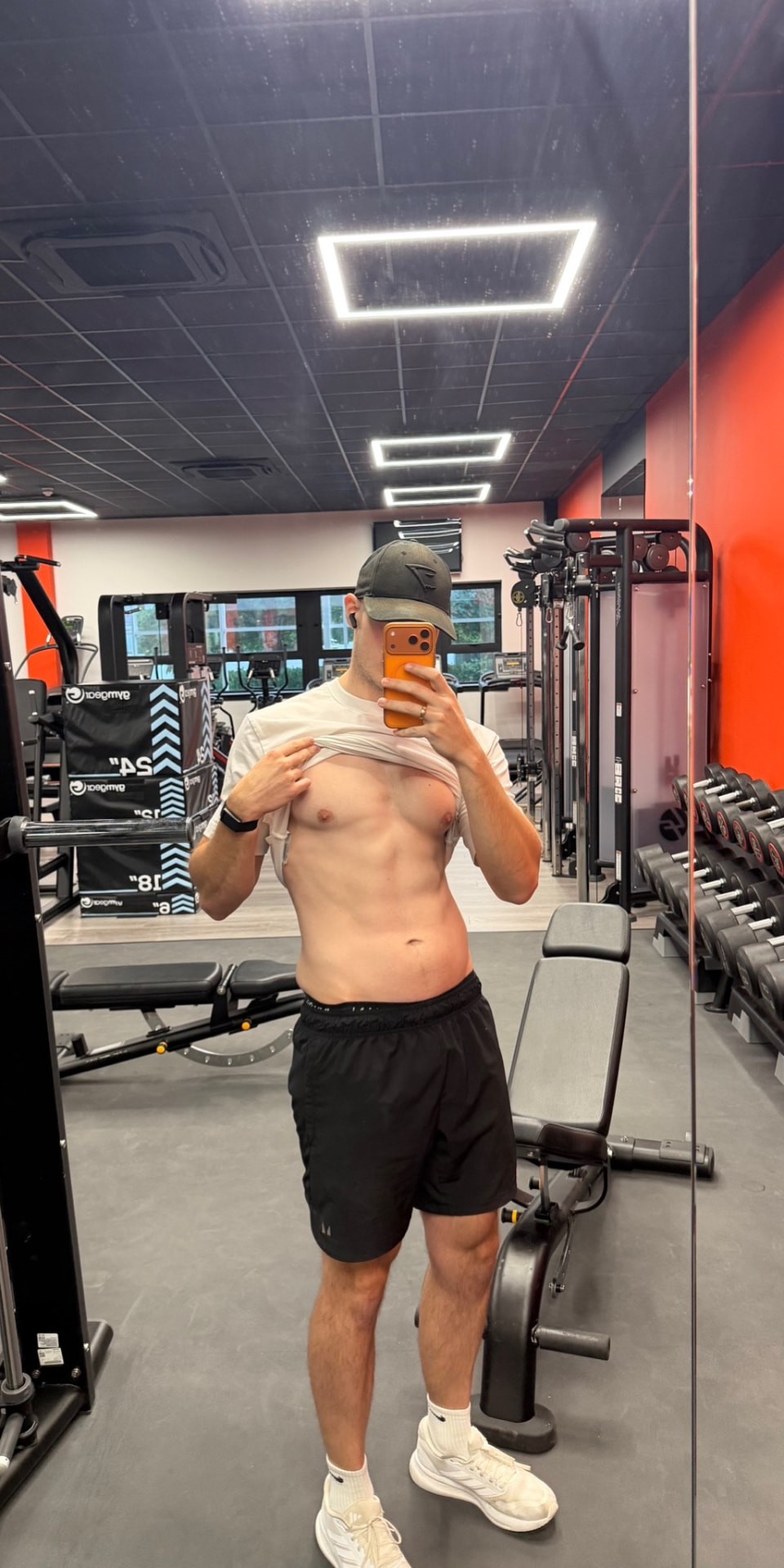 After photo — lean, athletic physique in the gym mirror